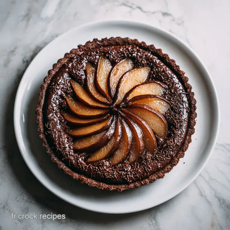 Slice of rich chocolate pear tart on a white plate, dusted with cocoa, highlighting the layers and glistening fruit.